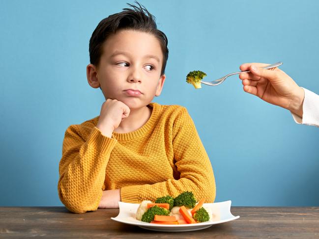 Child is very unhappy with having to eat vegetables. There is a lot of vegetables on his plate. He hates vegetables.