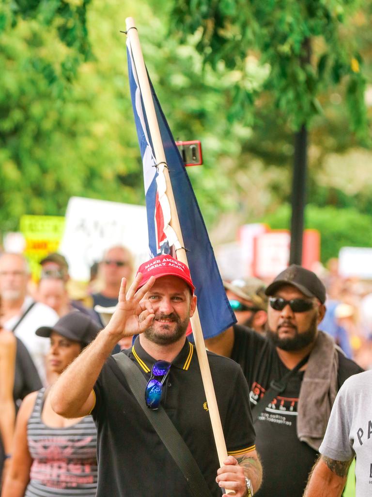 A protester gives the white supremacy OK sign as right wing agitators march among the crowds at a Free in the NT march in Darwin. Picture: Glenn Campbell