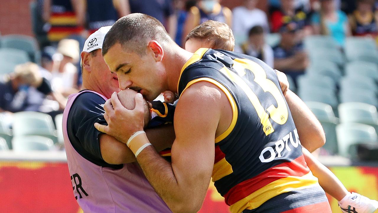 Taylor Walker of the Crows kisses his son before the 2021 AFL Round 01 match between the Adelaide Crows and the Geelong Cats