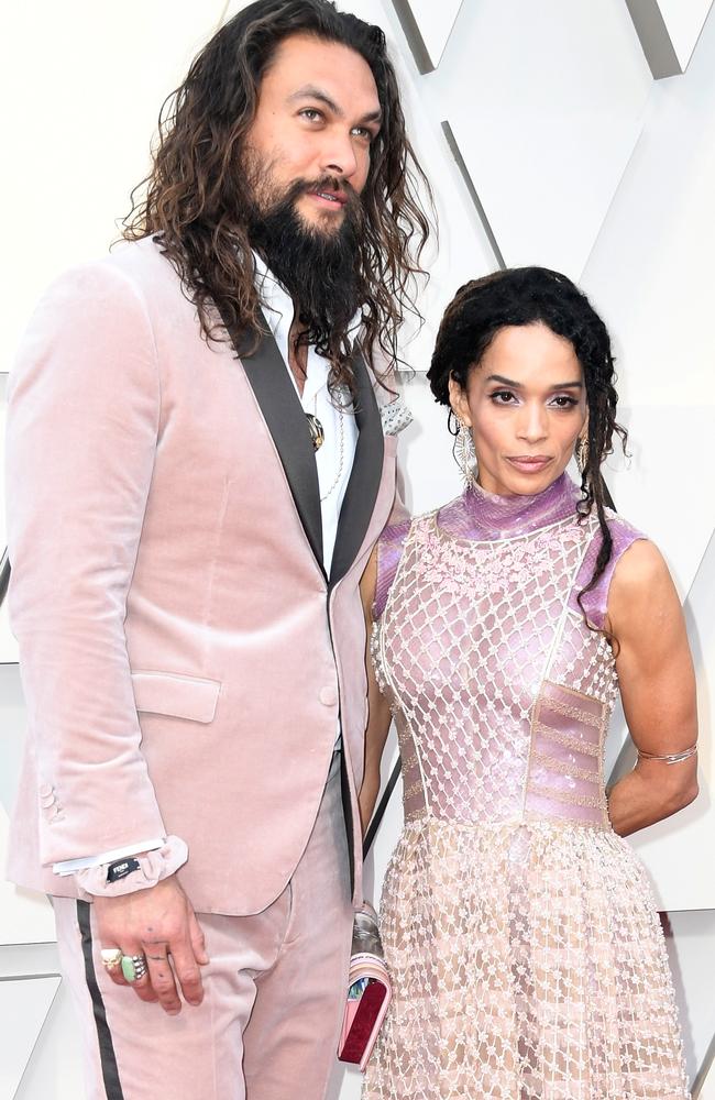 Pretty in pink: Jason Momoa and Lisa Bonet on the Oscars red carpet. Picture: Getty