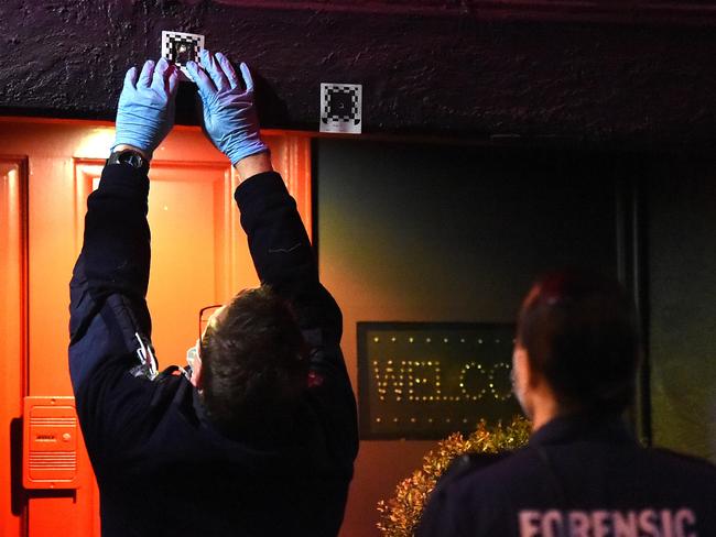 Officers mark out bullet holes. Picture: Nicole Garmston