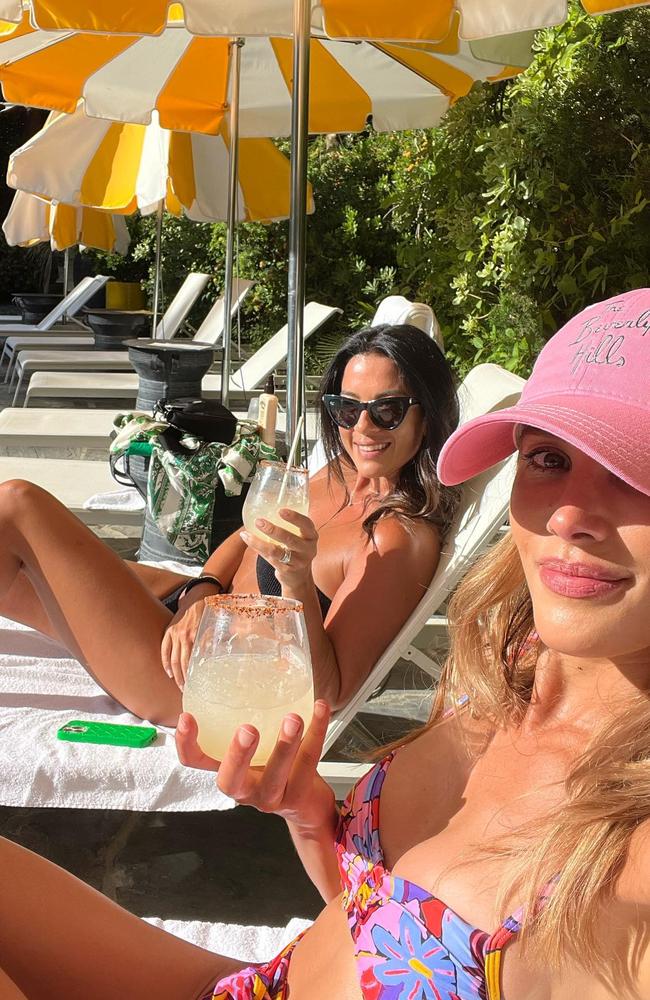 Bec and Michelle laying by the pool at their luxury hotel, La Quinta Resort &amp; Club. Picture: Instagram/becjudd