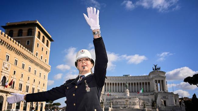 Cristina Corbucci directs traffic on Piazza Venezia in central Rome amid coronavirus restrictions. Picture: AFP.