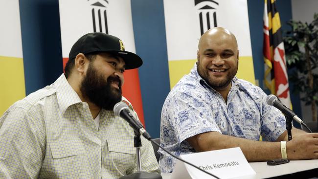 Chris Kemoeatu and his brother Ma'ake laugh during a news conference after their lifesaving operation.