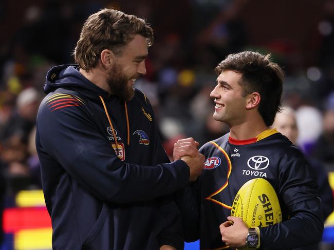 ADELAIDE, AUSTRALIA - JUNE 15: Riley Thilthorpe and Josh Rachele of the Crows before the 2024 AFL Round 14 match between the Adelaide Crows and the Sydney Swans at Adelaide Oval on June 15, 2024 in Adelaide, Australia. (Photo by James Elsby/AFL Photos via Getty Images)