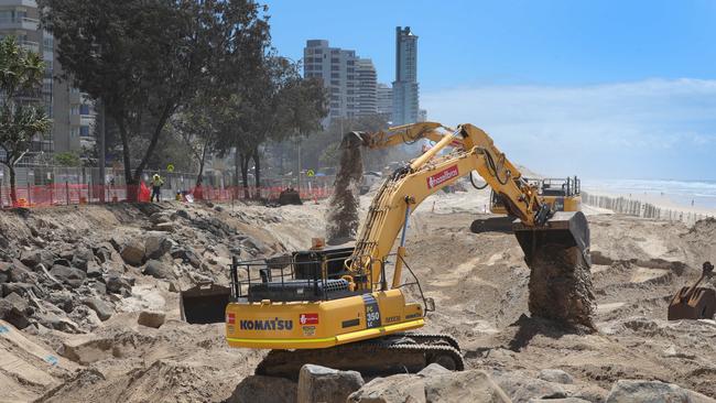 Work continues on the boulder wall at Surfers Paradise in preparation for the giant swell expected from the cyclone off the coast. Picture Glenn Hampson