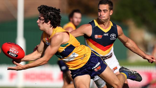 Eagles’ Jake Comitogianni gets a handball away under pressure. Picture: DEAN MARTIN