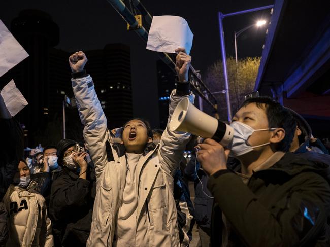 BEIJING, CHINA -NOVEMBER 28: Protesters shout slogans during a protest against Chinas strict zero COVID measures on November 28, 2022 in Beijing, China. Protesters took to the streets in multiple Chinese cities after a deadly apartment fire in Xinjiang province sparked a national outcry as many blamed COVID restrictions for the deaths. (Photo by Kevin Frayer/Getty Images) *** BESTPIX ***