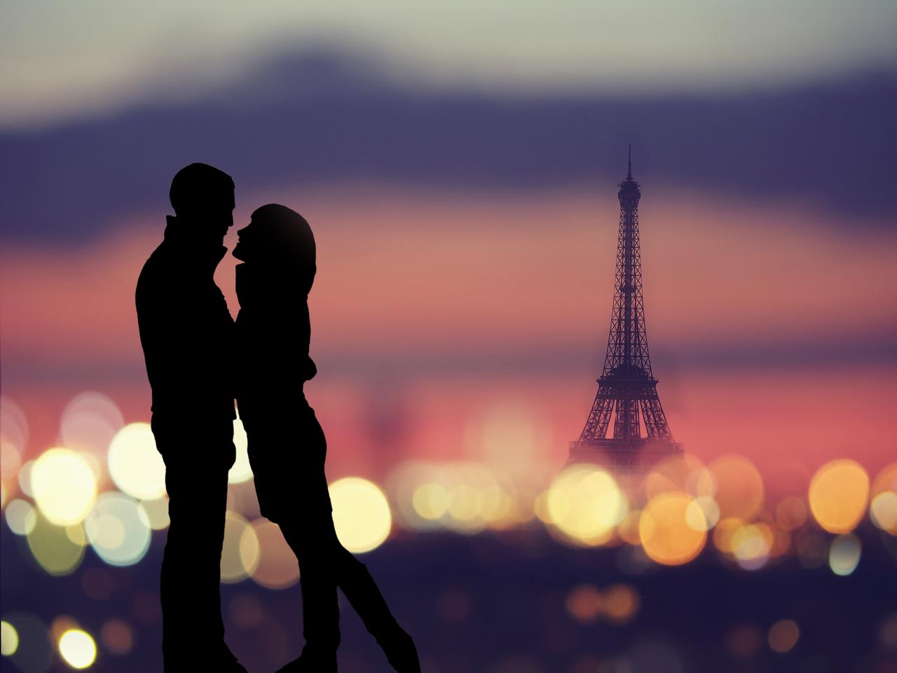 silhouette of romantic lovers with eiffel tower on a background in Paris , Franceabstract background : silhouette of romantic lovers with eiffel tower in Paris with sunset
