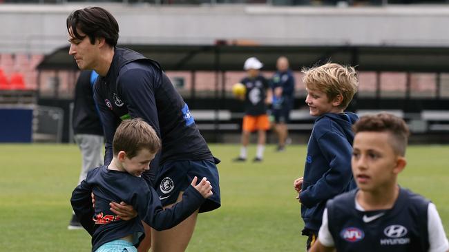 Carlton’s Zac Fisher tackles a young fan after training. Picture: Wayne Ludbey