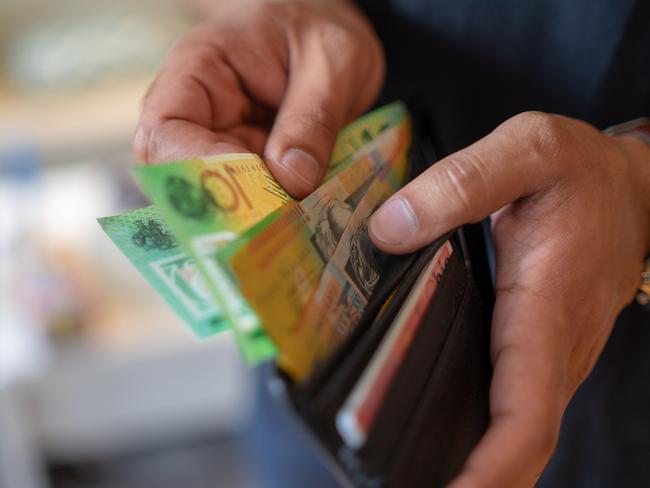 a male taking money out of the valet.