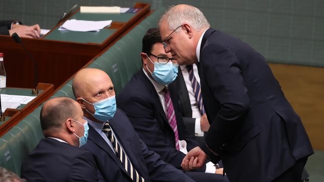 Prime Minister Scott Morrison speaks with Peter Dutton and Josh Frydenberg during a spiteful Question Time in the House of Representatives this week. Picture: NCA NewsWire / Gary Ramage