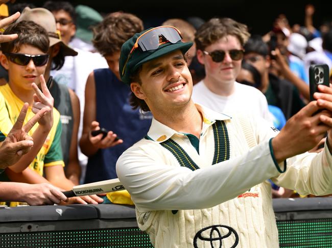 MELBOURNE, AUSTRALIA - DECEMBER 30: Sam Konstas of Australia takes a 'selfie' with fans during day five of the Men's Fourth Test Match in the series between Australia and India at Melbourne Cricket Ground on December 30, 2024 in Melbourne, Australia. (Photo by Quinn Rooney/Getty Images)