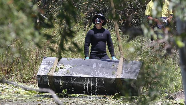 The toolbox containing the bodies of Mr Breton and Ms Triscaru is lifted from the lagoon at Scrubby Creek in February 2016.