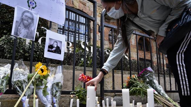 A fan of US band Foo Fighters places candles outside Casa Medina Hotel where the band's drummer Taylor Hawkins was found dead in Bogota, Colombia. Picture: Guillermo Legaria/Getty Images