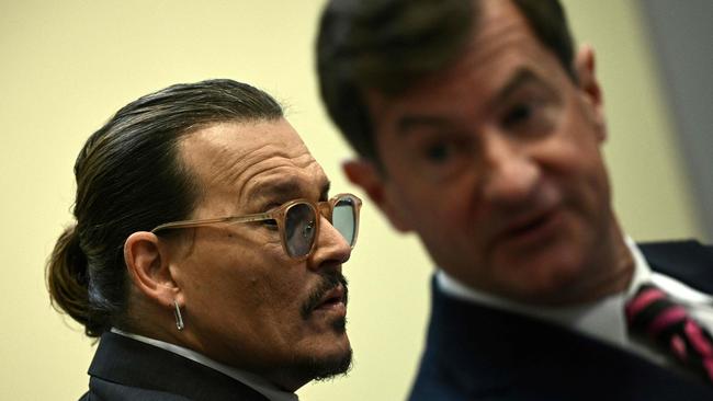 US actor Johnny Depp and his lawyer Ben Chew arrive in the courtroom gallery. (Photo by BRENDAN SMIALOWSKI / POOL / AFP)