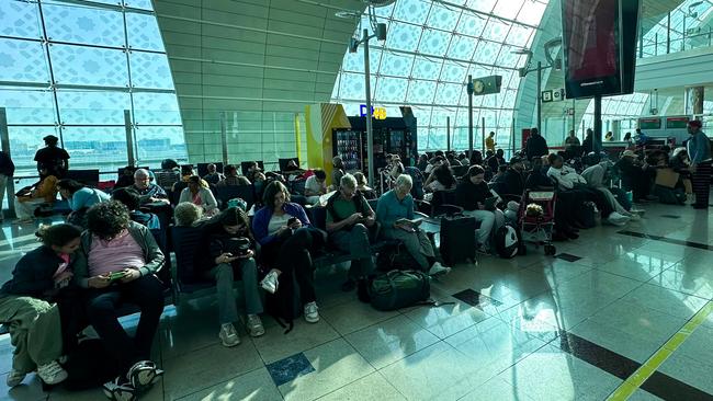 Exhausted passengers wait for news of their flights in Dubai on April 17. Picture: AFP