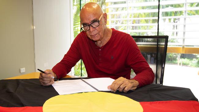 The designer of the Aboriginal flag, Harold Thomas, signs over copyright to the Commonwealth of Australia. Picture: David Hancock