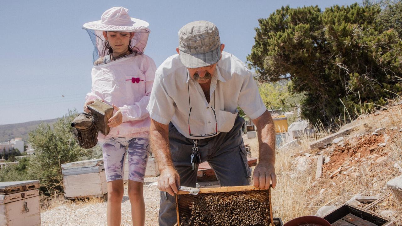 Markos his granddaughter Markela have noticed there are less bees due to climate change. Picture: UNICEF/Anna Pantelia