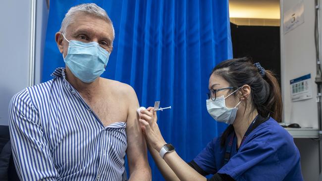 Oncologist Grant McArthur, a prostate cancer survivor, receives a COVID-19 vaccine from nurse Serena Lin in Melbourne last week. Picture: Jake Nowakowski