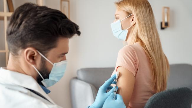 A woman gets a Covid vaccine shot.