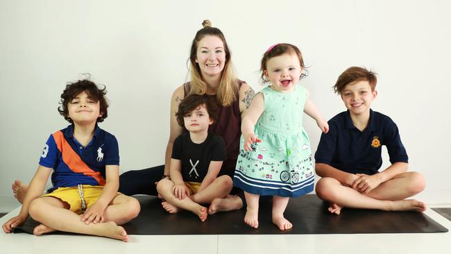 Bucking the trend … mother of four Casey Castro, 37, with her children Reino, 6, Monty, 3, Edie, 1, and Jupiter, 9, at her yoga studio in Sydney’s Bondi Junction. Picture: John Feder