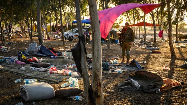 Members of security forces search for identification at the Supernova Music Festival site, where hundreds were killed and dozens taken by Hamas militants. Picture: Getty