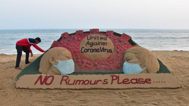 Indian artist Sudarsan Pattnaik puts some final touches as he makes a sand sculpture. Picture: AFP