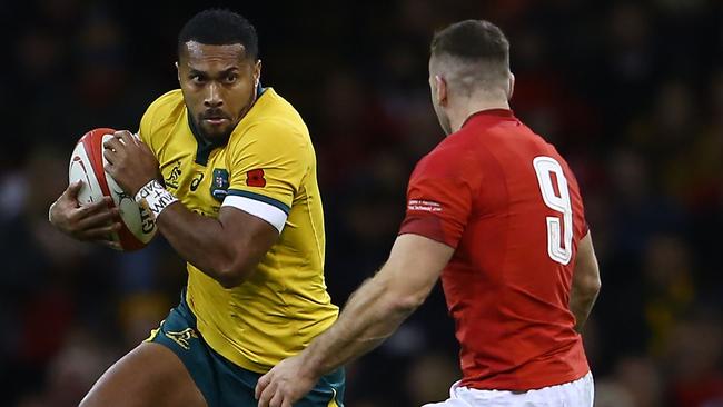 Australian winger Sefa Naivalu takes on Wales’ scrum-half Gareth Davies. Picture: AFP