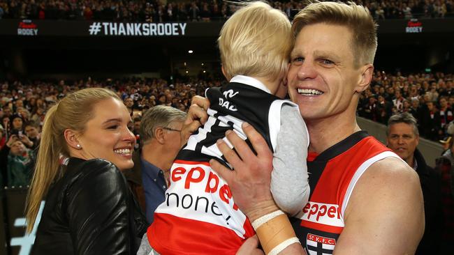 Nick Riewoldt takes son James from wife Catherine after playing his final game. Pic: Michael Klein.