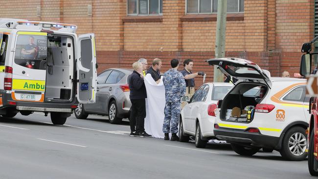 Paramedics attending to a patient who later died after a road accident on Davey St this morning. Picture: MATHEW FARRELL