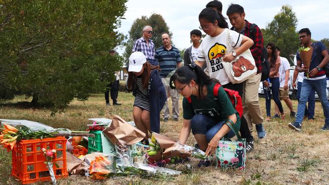 A group of students from nearby La Trobe University lay flowers for Aiia Maasarwe. Picture: Aaron Francis