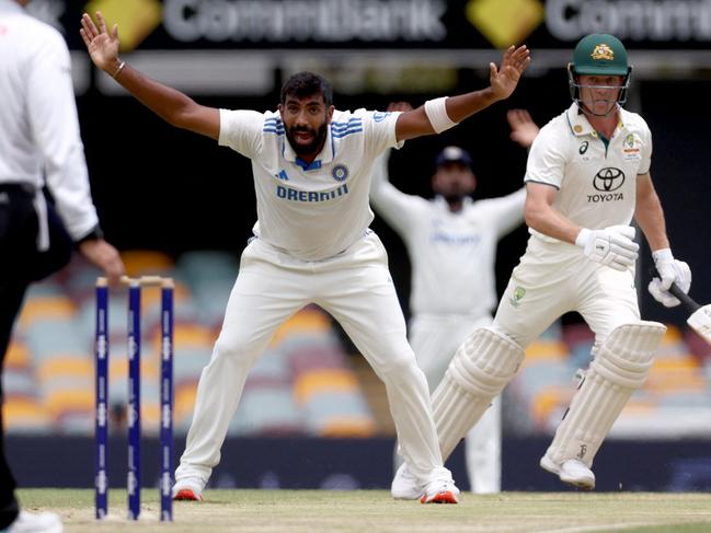 TOPSHOT - Indiaâs Jasprit Bumrah (C) appeals unsuccessfully for LBW for Australiaâs Nathan McSweeney (R) on day five of the third cricket Test match between Australia and India at The Gabba in Brisbane on December 18, 2024. (Photo by DAVID GRAY / AFP) / -- IMAGE RESTRICTED TO EDITORIAL USE - STRICTLY NO COMMERCIAL USE --