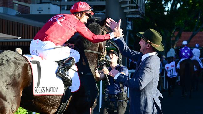 Ryan Maloney and Ciaron Maher celebrate their Group 1 Queensland Oaks boilover with Socks Nation at Eagle Farm. Picture: Grant Peters / Trackside Photography