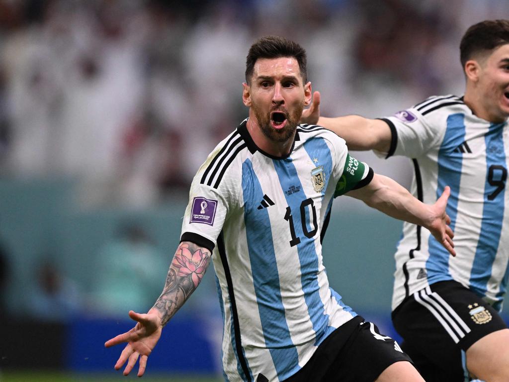 Argentina's forward #10 Lionel Messi celebrates scoring the opening goal with his teammate Argentina's forward #09 Julian Alvarez during the Qatar 2022 World Cup Group C football match between Argentina and Mexico at the Lusail Stadium in Lusail, north of Doha on November 26, 2022. (Photo by Kirill KUDRYAVTSEV / AFP)