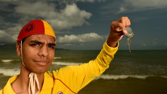 Acadian Surf Life Saving club member with a small bluebottle jellyfish on the Strand on Sunday. Picture: Evan Morgan