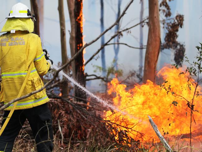 Rural Fire Service volunteers and firefighters are battling blazes across the state, including Rainbow Flat, on the mid-north coast. Picture: Peter Lorimer