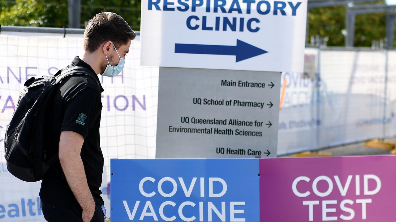 A masked man walks outside a COVID-19 vaccine and testing clinic in Brisbane. Picture: NCA NewsWire / Dan Peled