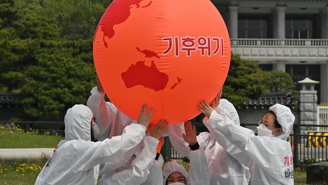 Environmental activists take part in an Earth Day rally against climate change near the presidential Blue House in Seoul on April 22. Picture: AFP