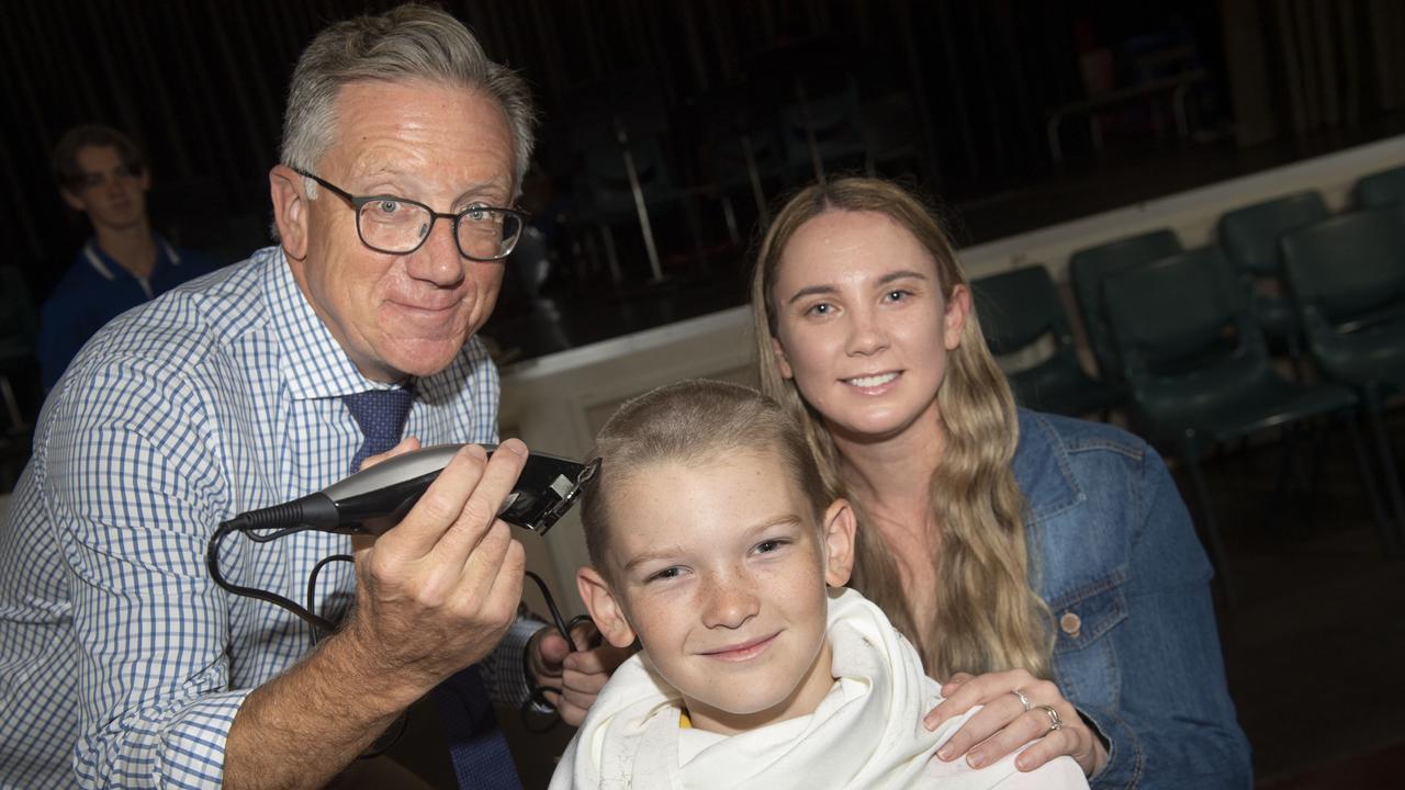 Glenvale State School principal David Saxton shaves the hair of student Danny Booth watched by Danny's mother Lisa Booth. Monday, March 28, 2022. Picture: Nev Madsen.