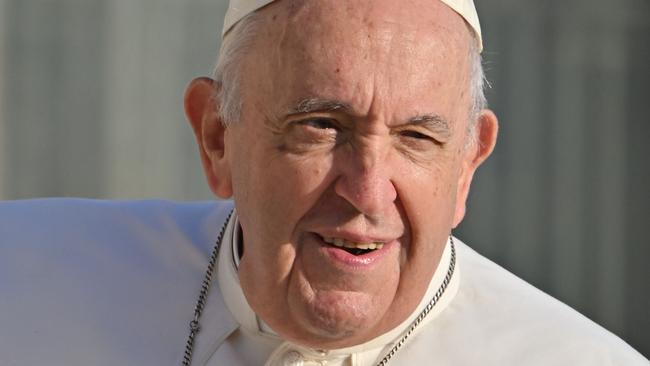 (FILES) Pope Francis arrives for the weekly general audience on October 19, 2022 at St. Peter's square in The Vatican. Pope Francis "rested well" the Vatican said on February 25, 2025, as the critically-ill pontiff is in hospital with double pneumonia. (Photo by Alberto PIZZOLI / AFP)