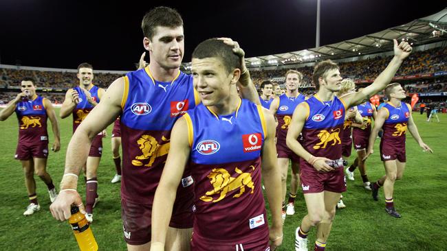 Sam Sheldon leads the team off the Gabba after the victory. Picture: Darren England.