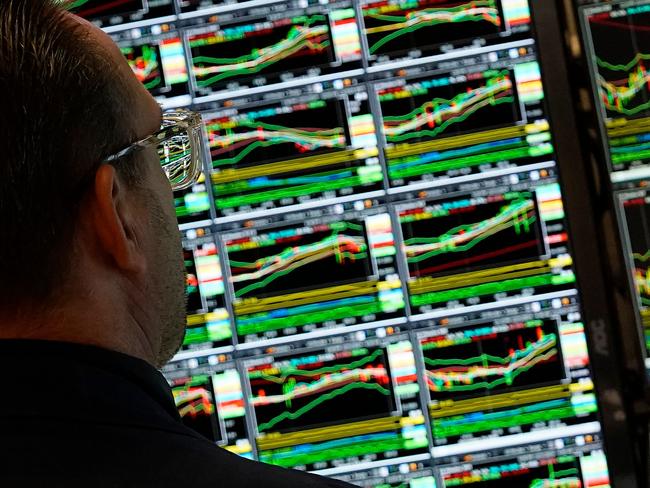 A trader works at his desk on the floor of the New York Stock Exchange (NYSE) during the first session of the new year on January 2, 2025, in New York City. (Photo by TIMOTHY A. CLARY / AFP)