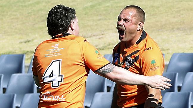 Runaway bookend: Prop Tony Campbell is greeted by Jaydn Phillips (No.4) after crossing for the Tigers’ final try. Picture: John Appleyard