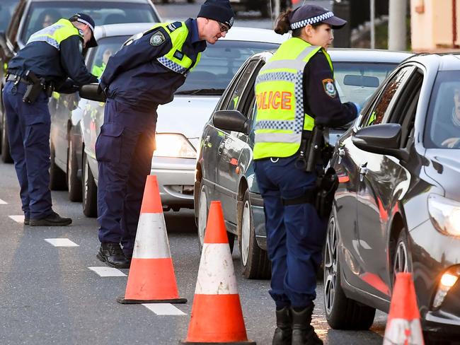 Police in Albury check cars crossing the state border from Victoria on Wednesday. Picture: William West/AFP