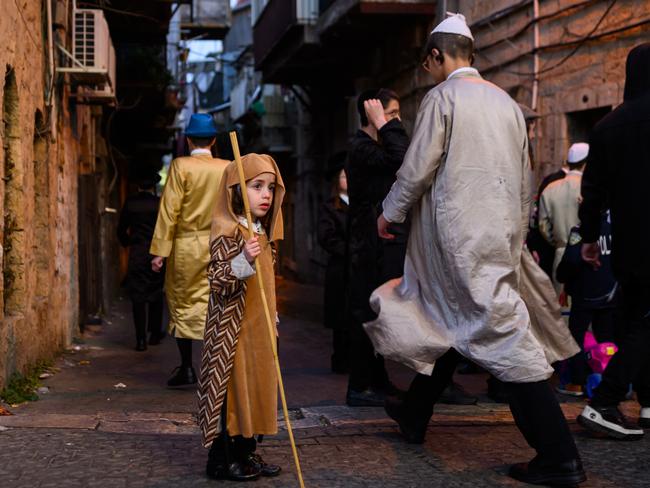 An Ultra-Orthodox Jewish boy wearing a costume celebrates Purim in the neighbourhood of Mea Shearim in Jerusalem. Picture: Alexi J. Rosenfeld/Getty Images