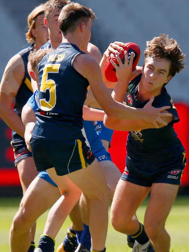 Rhylee West bursts through a tackle during a match between the AFL Academy and North Melbourne VFL. Picture: Getty Images.