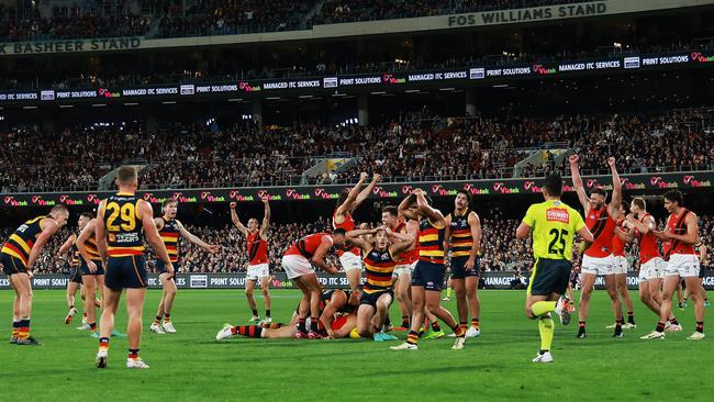 ADELAIDE, AUSTRALIA - APRIL 19: The Crows react as The Bombers celebrate their win during the 2024 AFL Round 06 match between the Adelaide Crows and the Essendon Bombers at Adelaide Oval on April 19, 2024 in Adelaide, Australia. (Photo by James Elsby/AFL Photos via Getty Images)