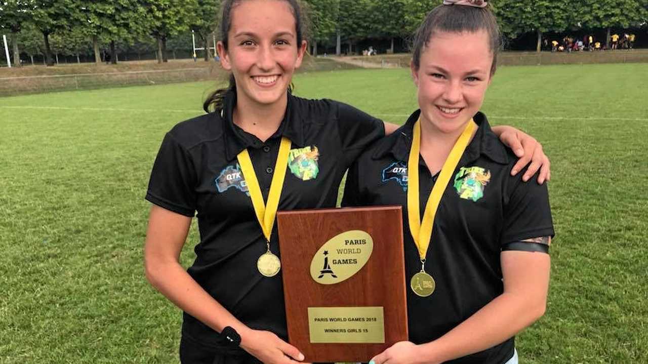 DYNAMIC DUO: Chloe Cocks (left) and Holly Anlezark celebrate their Paris World Games Rugby Sevens victory. The University Saints and West Bulldogs duo were part of the Tribe Rugby Sevens representative team that went through the competition undefeated. Picture: Contributed