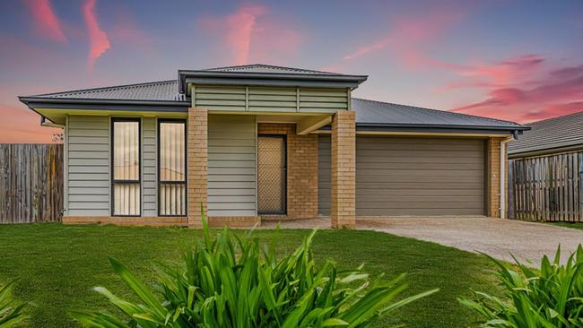 This four-bedroom house at 27 Adam St, Beachmere, has a price guide in the high $400,000s.